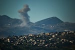 Buildings damaged by Israeli strikes are seen through shattered glass from the Jabal Amel Hospital in the southern port city of Tyre, Lebanon, Thursday, June 18, 2026.