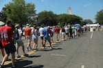 Attendees walk to attend Independence Day events honoring the nation's 250th anniversary, Saturday, July 4, 2026, on the National Mall in Washington.