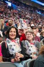 Rita Dillon-Drake, left, and friends pose for a portrait holding Pancake cutout signs.