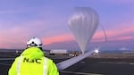An inflation tube runs helium into the upper section of the balloon.