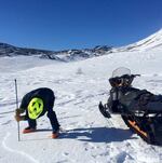 A snow-machine rider takes a snowpack reading as part of Community Snow Observations, a NASA-sponsored citizen science project.