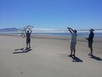 Members of the e-Wind Solutions team at beach with one of their kites.