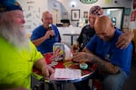 From left, electricians Mike Kane, Rick Lebel, Scott Young and Jimmy Ortega, laugh together at IBEW Brotherhood Night at Monkey N’Around Pizza on Thursday, July 17, 2025, in Quincy, Washington.