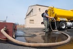 Ranzy Robinson with Campbell Forestry, a land clearing and defensible space company contracted with the Oregon Department of Forestry, refills a tank of water for aircrafts fighting the Bench Fire outside the Madras Municipal Airport in Madras, Ore., near the Bench Fire on July 28, 2026.