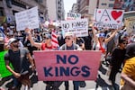 Demonstrators take part in a protest against the Trump administration during the "No Kings" national rally in downtown Los Angeles on June 14, 2025, on the same day as President Trump's military parade in Washington, D.C.