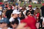 A man wearing a QAnon t-shirt walks through the crowd at a Trump rally on Sept. 25, 2021 in Perry, Ga. The nonprofit PRRI, which conducts polls on religion, found that 19% of Americans believe in the core theories associated with QAnon, up from 14% in 2021. The poll found the number rose to 32% among Republicans who support Trump.