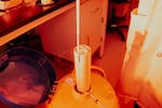 Tie pulls out frozen human embryos carrying disease-causing mutations from a cryogenic storage unit at Origin Genomics new labs.