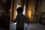 Sami Abu Ali, grandson of Raeda Jamil Abu Ali, 3, plays beside a door that was broken by Israeli soldiers in hi home in the Refugee camp in Jenin, Palestine on September 18, 2024. The Israeli army raided her home and used it as a position for 4 days because of the views from the top floors. Effectively holding the Abu Ali family household hostage, where 26 members of the extended family were living, including 8 children, spread over three floors.The Army left the home severely damaged including breaking down doors and walls so they could walk through the complex including the main floor apartment which was left completely charred and covered in debris after a rear was blasted through with a gas canister, leaving a large gaping hole. The trauma of this event has left the children in an agitated state.