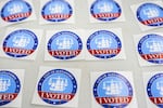 "I Voted" stickers are laid out on a table at Lyles-Crouch Traditional Academy on election day for the Virginia redistricting referendum, Tuesday, April 21, 2026, in Alexandria, Va.