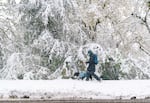 A pedestrian walks along Barnes Rd. in Portland, April 11, 2022. 