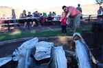 Visitors to Kah-Nee-Tah watch salmon being cooked over an open flame for the resort's final weekend dinner. 