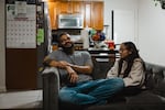 Christopher Santiago, 38, hangs out at home in Alsip, Ill., with one of his three children, 9-year-old Calliope. He says Cook County's basic income program has let him provide more for his kids.