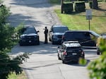 Law enforcement block a street in Bethel Park, Pa., that they say was a residence of Thomas Matthew Crooks, the suspected shooter of former President Donald Trump, on Sunday. 