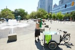 FILE - Matthew Carr dries himself after cooling off in the Salmon Street Springs fountain in Portland, Ore., July 26, 2022. 