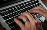 FILE - A person works on a laptop in North Andover, Mass., on June 19, 2017. Cyberattacks can be very costly and time consuming if organizations don’t have a plan to deal with them. Oregon’s Department of Environmental Quality recently survived a massive cyber attack. 