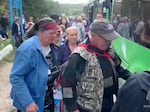 Russians in the western region of Kursk board a bus Monday as part of a large-scale evacuation in the wake of a Ukrainian military operation. Russian officials say more than 100,000 civilians have fled Kursk in the past week.
