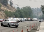 A procession of emergency responders line South Canyon Boulevard in John Day, as a the body of a pilot is transported to Driskill Memorial Chapel, July 26, 2024. The pilot was killed in the crash of a single engine air tanker tanker on Thursday, near the Falls Fire area.