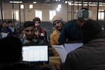 At a registration center in Lucknow, Indian men submit their data, as recruiters seek thousands of skilled laborers to work in Israel.