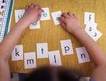 A student sorts reading flashcards in a first grade class in Southeast Portland on March 29, 2022. Oregon has a list of approved curricula school districts can choose from, but each district can select other options without penalty — meaning some schools are using discredited systems for teaching reading.