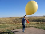 Mitchell Erickson launches a weather balloon in South Dakota on April 7, 2004.