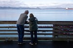 David and Cindy Parker write “53 years” on a heart-shaped padlock and lock in on Pier 39 in celebration of their love in Astoria, Ore., on Feb. 12, 2026.