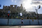 People participate in the 13th annual International Jerusalem Marathon on Friday, March 8, in Jerusalem. Many participants this year wore shirts and ran with signs raising awareness for the hostages kidnapped on Oct. 7 by Hamas and still being held in Gaza.