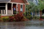 Steve Odom stands on the porch of his home that is surrounded by flood waters caused by Hurricane Idalia passing offshore in Tarpon Springs, Florida.