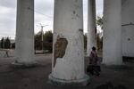 A woman exits a building after receiving humanitarian aid in Dobropillya, Ukraine, on Oct. 17. Dobropillya frequently comes under aerial attack from Russian missiles and drones.