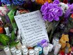 The names of the 10 people killed in Saturday's shooting at Tops market are part of a makeshift memorial across the street from the store on May 17 in Buffalo.