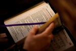 A college student looks through her prayer book. A new study found a decline in Christianity in the U.S. (AP Photo/Charlie Riedel)