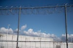 FILE — A fence outside the Northwest ICE Processing Center on Tuesday, Sept. 10, 2019, in Tacoma, Wash.