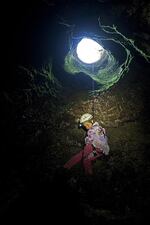 Aspen rappels into a cave as a small girl. “She’s never really known a life that didn’t include caving and research in the field with invertebrates,” her father says.