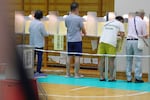 Voters fill in their ballots in the upper house election at a polling station Sunday, July 20, 2025, in Tokyo.