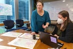 Dr. Marisa Zapata, left, and project manager Carolyn Niehaus work together at the regional Incident Command Center in Portland, for the Point in Time Count of homelessness, Jan. 25, 2023. This year marks the first time that the region’s three counties have used a common analysis, a regional Incident Command Center and an app that helps bring data in real-time.