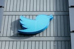 The Twitter logo is seen on a sign on the exterior of Twitter headquarters in San Francisco, California, on October 28, 2022.
