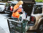 A woman loads her car at a food pantry in Norfolk, Virginia. Inflation sent food prices soaring just as emergency pandemic support for many people ended.