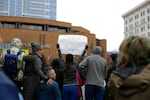 A sign reads "Policy not prayers" at the Portland March For Our Lives.