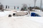 Abandoned trucks block lanes along Route 20 after an intense lake-effect snowstorm impacted the area on Saturday in Hamburg, New York.