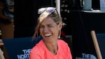 Stephanie Case sits during an ultramarathon race in Wales and breastfeeds her 6-month-old baby, Pepper.