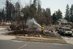 Firefighters visit burned homes to put out hot spots on the properties to prevent new blazes.