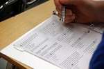 FILE - In this photo taken Jan. 17, 2016, a student looks at questions during a college test preparation class at Holton Arms School in Bethesda, Md. Some colleges and universities will again require ACT or SAT scores with applications for admissions, but so far no Oregon schools have said they will do so.