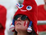 A Canada fan dons an Olympic mascot Phryge hat before the women's quarter-final football match between Canada and Germany during the Paris Olympics.