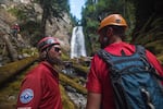 The safety and rigging team, Jared Smith, left, and Mike Williams, right, stand below the waterfall nicknamed "NE Shangri-La."