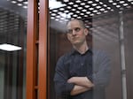 Evan Gershkovich, accused of espionage, looks out from inside a glass defendants' cage prior to a hearing in Yekaterinburg's Sverdlovsk Regional Court on June 26.