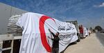 Egyptian Red Crescent trucks loaded with aid queue outside the Rafah border crossing with the Gaza Strip on March 23. After months of very limited aid deliveries to Gaza, the pace is picking up this week. More than 400 trucks are entering Gaza daily, according to Israel. This is more than double the previous rate.