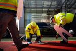 City of Portland utility workers place the letters for the new "Bus Only" sign on the red transit lane.