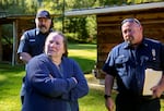 Becky Watkins worked with Deputy Fire Marshals Rich Holloway, right, and Bryan Dorris, left and behind, to improve her Days Creek, Ore., home's wildfire defenses on April 18, 2024.