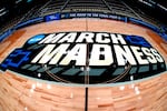 FILE - March Madness logo sis displayed at center court during the opening rounds of the NCAA college basketball tournament in Pittsburgh, Wednesday, March 20, 2024.