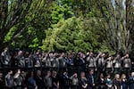 Members of Cowlitz County law enforcement stand at attention as the funeral procession for Cowlitz County Sheriff's Deputy Justin DeRosier arrives at the Chiles Center on April 24, 2019, in Portland, Oregon.