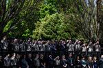 Members of Cowlitz County law enforcement stand at attention as the funeral procession for Cowlitz County Sheriff's Deputy Justin DeRosier arrives at the Chiles Center on April 24, 2019, in Portland, Oregon.